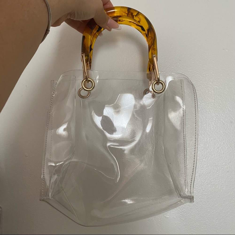 Clear bag with a tan leather bag